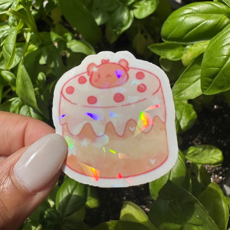 A die-cut sticker featuring a cute bear themed cake sticker , set against a background of a cozy garden. Stickers for water bottle, laptop sticker, cute sticker, cool sticker 