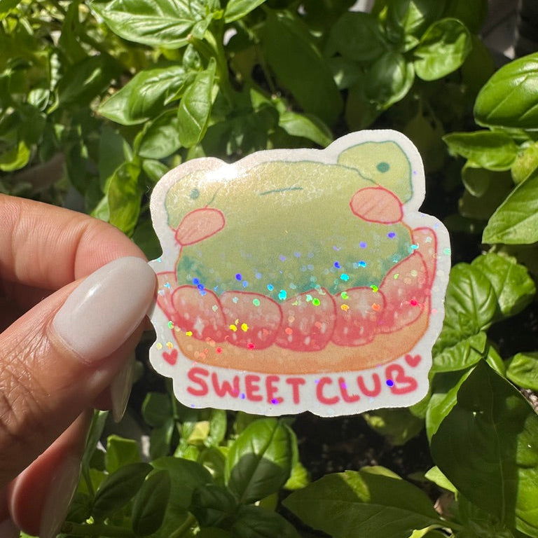 A die-cut sticker featuring strawberry frog danish cake sticker , set against a background of a cozy garden. Stickers for water bottle, laptop sticker, cute sticker, cool sticker 