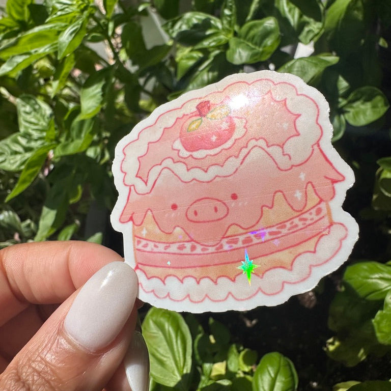 A die-cut sticker featuring a cute pink pig themed cake sticker , set against a background of a cozy garden. Stickers for water bottle, laptop sticker, cute sticker, cool sticker 