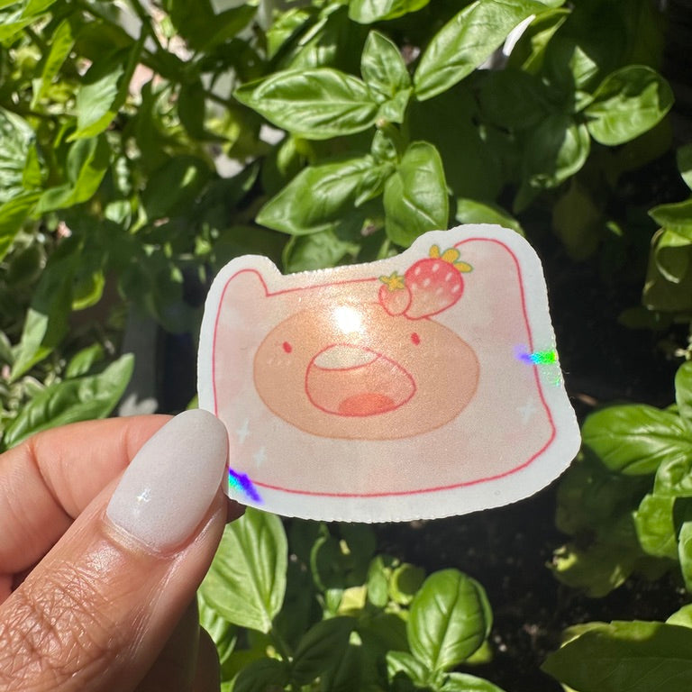 A die-cut holographic sticker of the cartoon character Finn the Human with a strawberry. Cute Adventure time sticker. Stickers_for_water_bottle_laptop_sticker_cute_sticker_cool_sticker_honeycraft_sticker