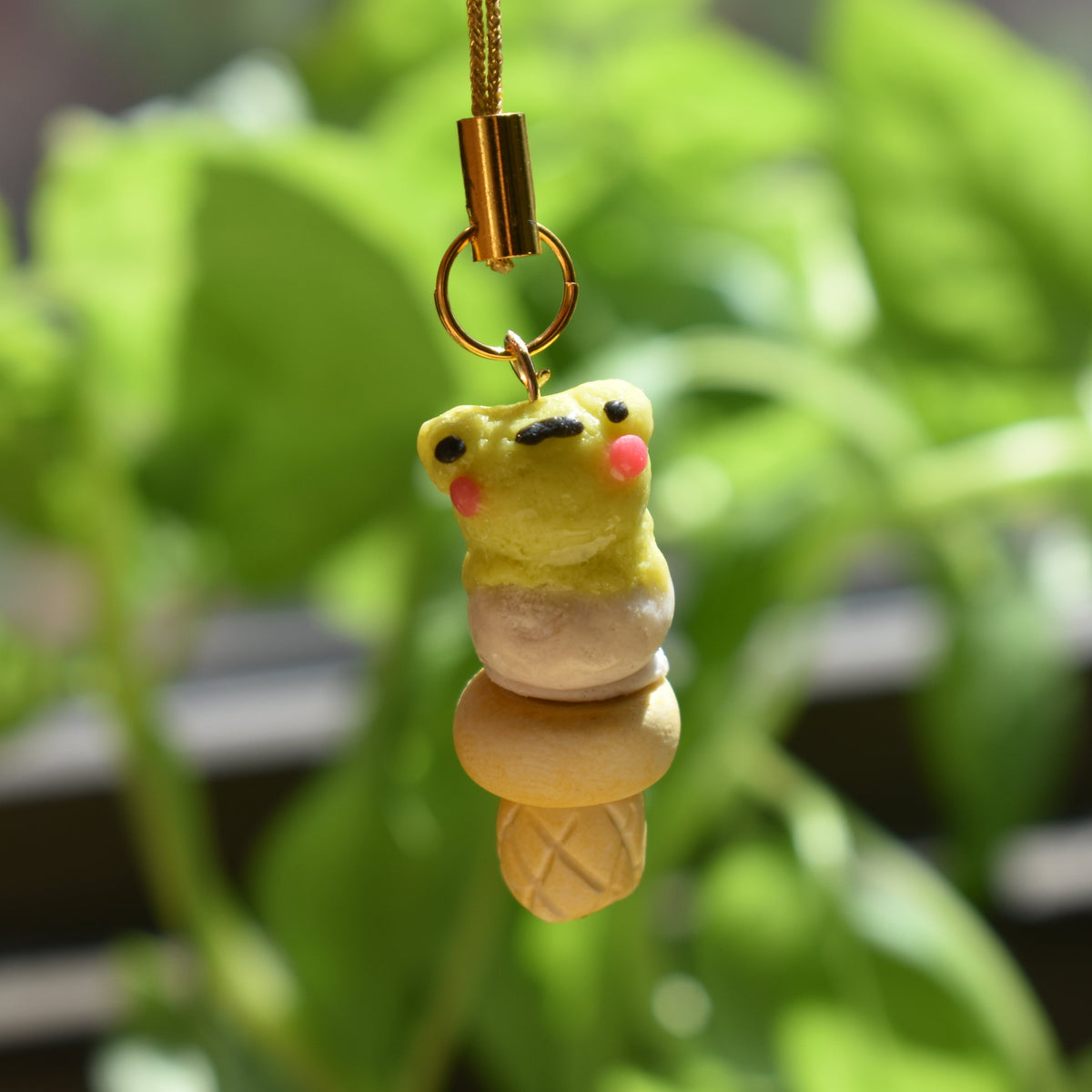 Frog-themed ice cream phone charms necklaces are held in a hand. Cute polymer clay keychain , polymer clay jewelry  