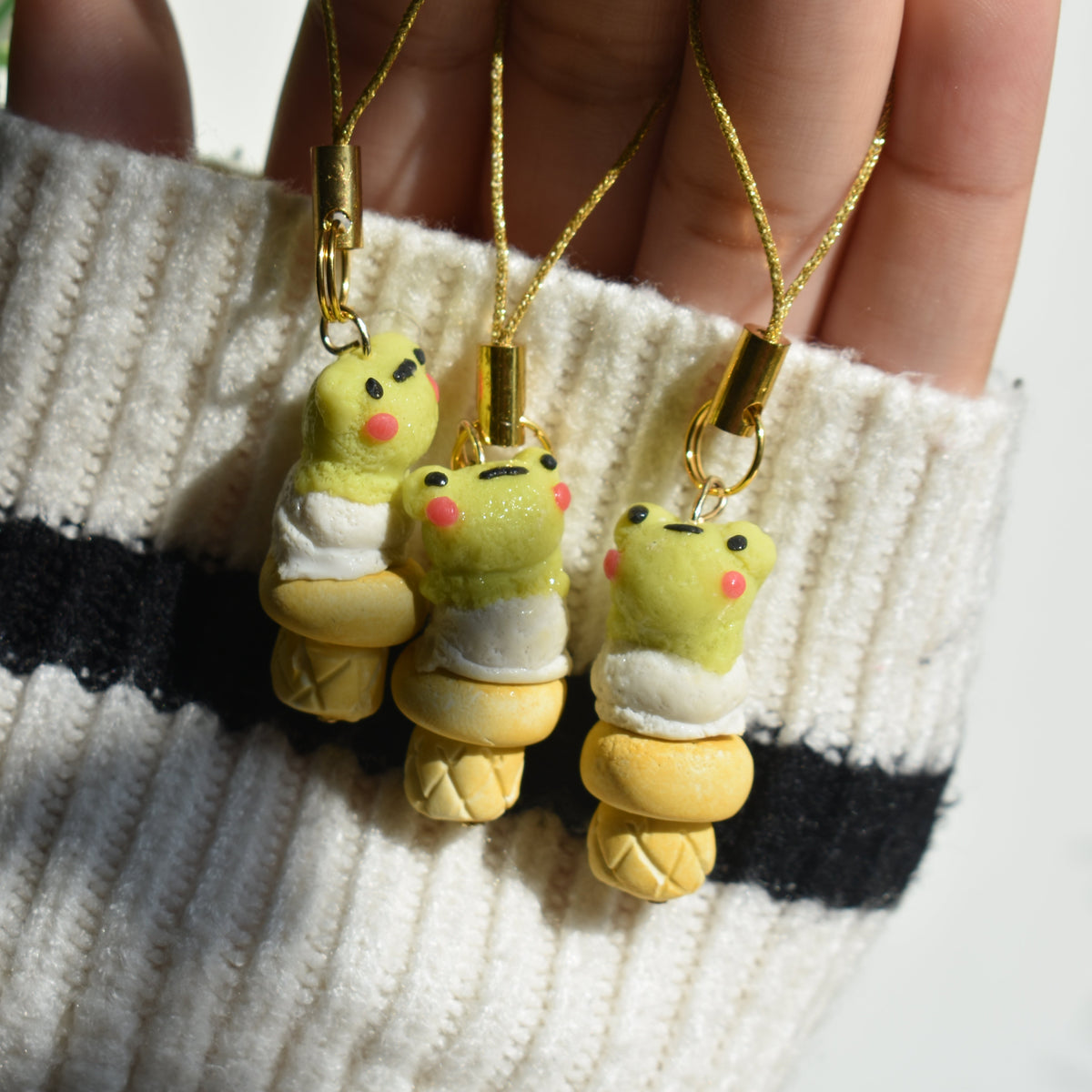 Frog-themed ice cream phone charms necklaces are held in a hand. Cute polymer clay keychain , polymer clay jewelry  